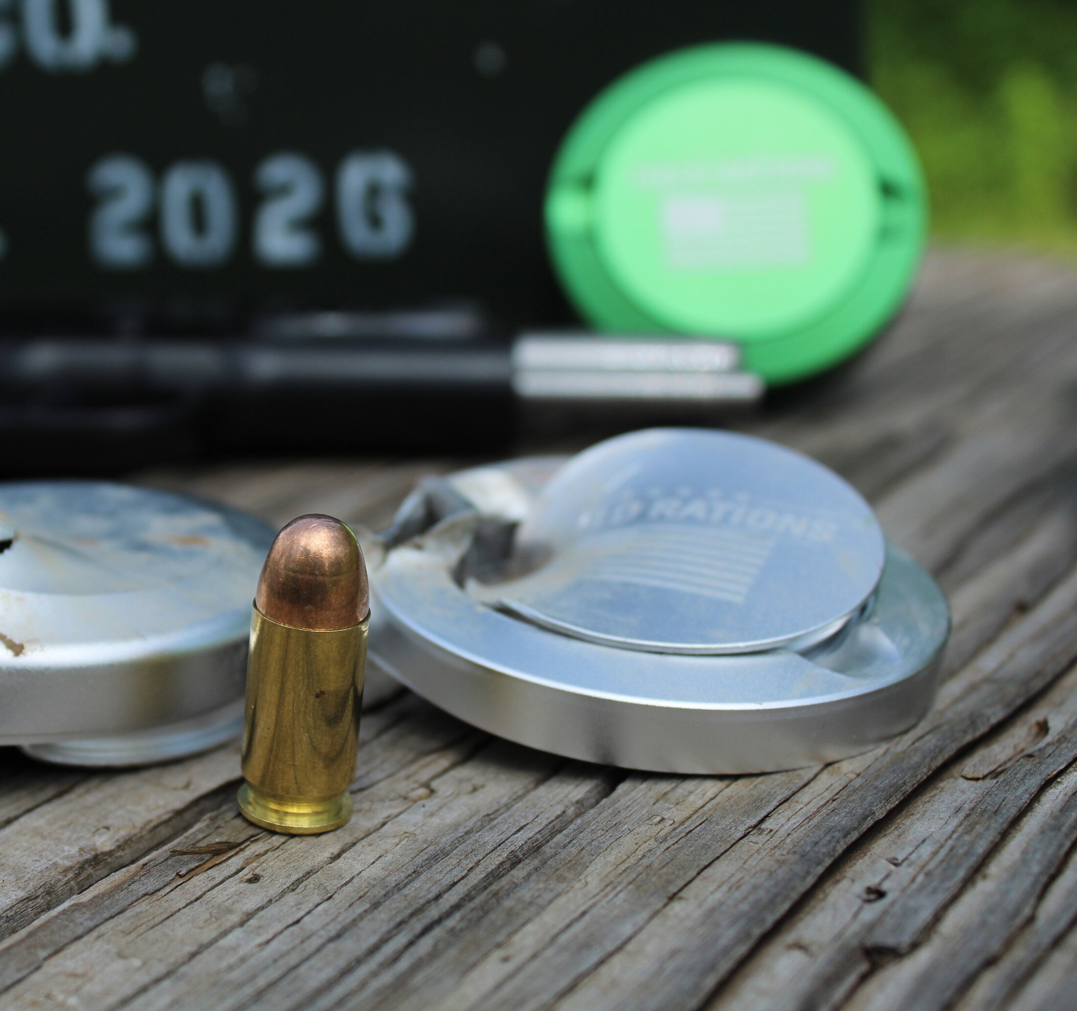 Field-tested silver cans next to a .45 round
