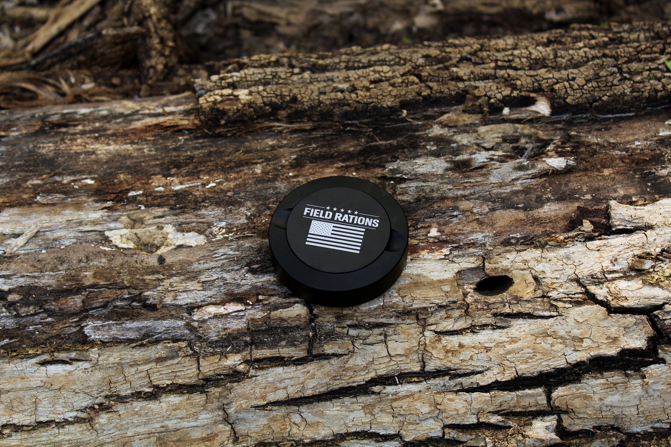 The Operator — Black Field Rations can on bark